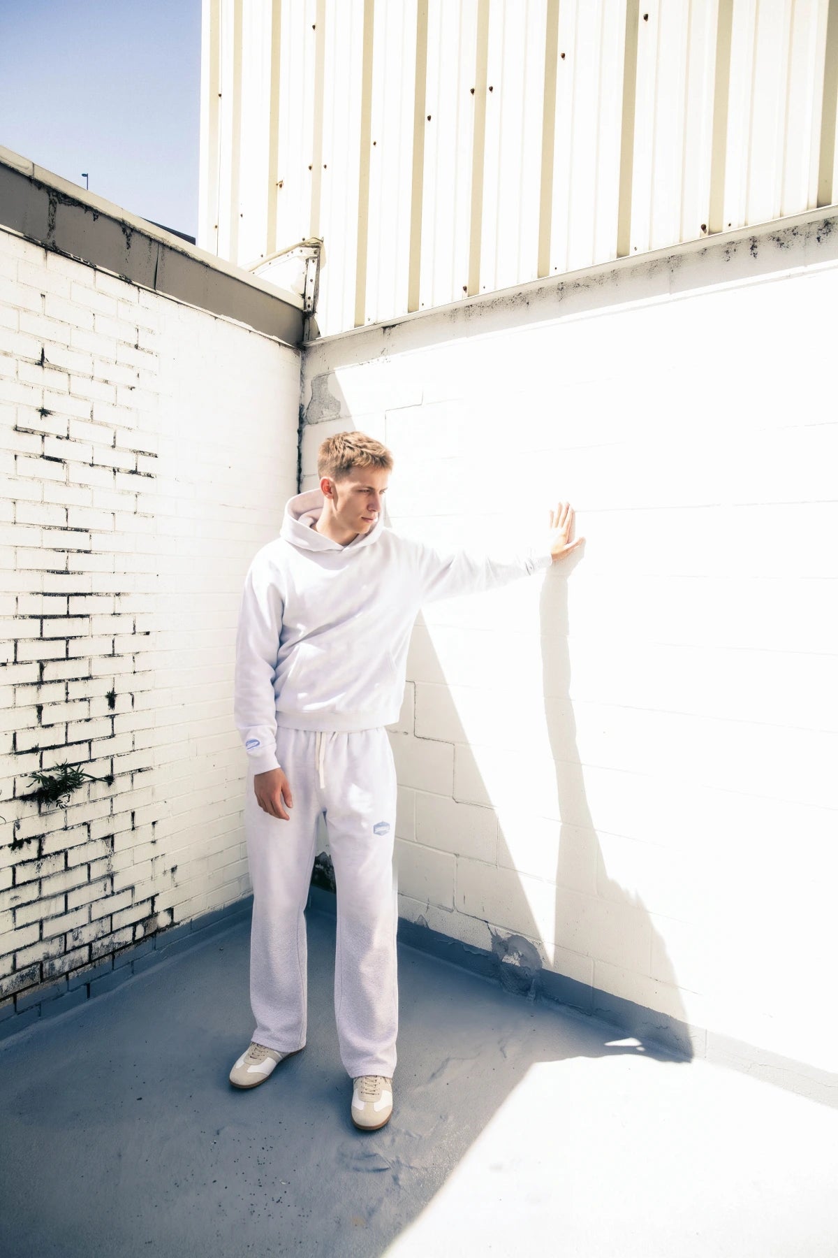 Ash heather sweatset by a sunlit wall, final M3 0411